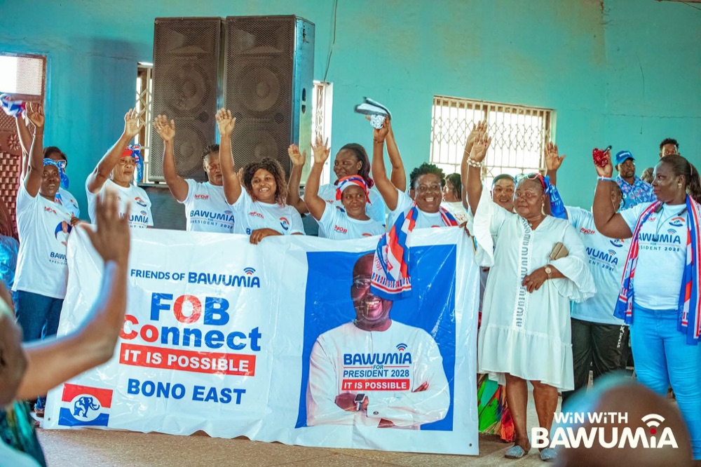 A group of FOB members with a Bono East community banner